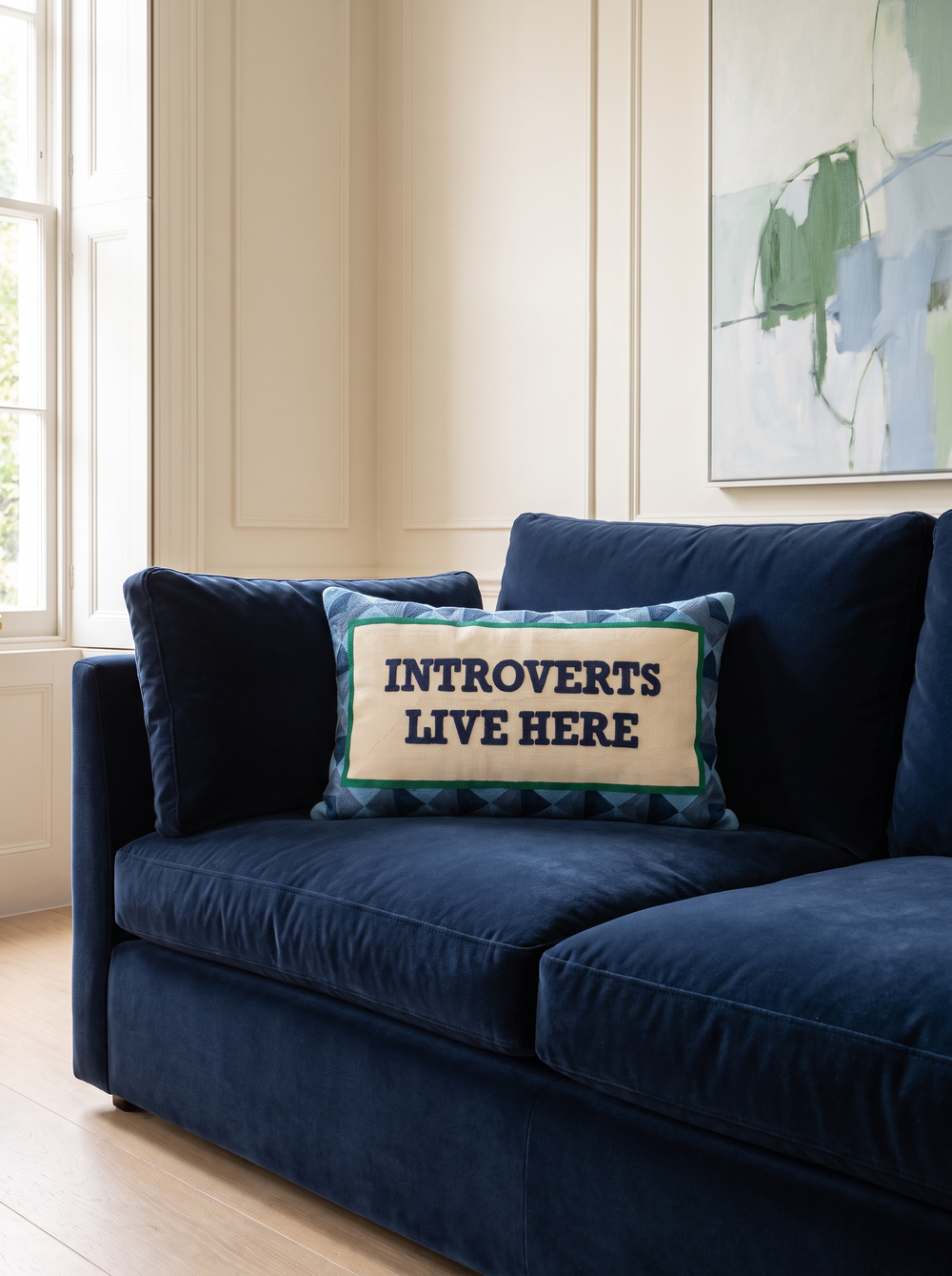 Introverts Live Here needlepoint cushion styled at home