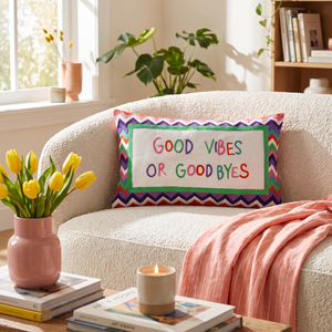 Good Vibes or Good Byes needlepoint cushion styled in a bright living room