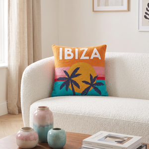 Ibiza Sunset needlepoint cushion styled in a living room