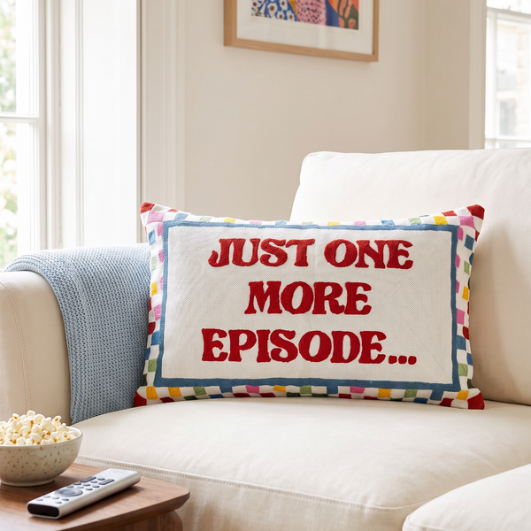 Just One More Episode needlepoint cushion styled at home