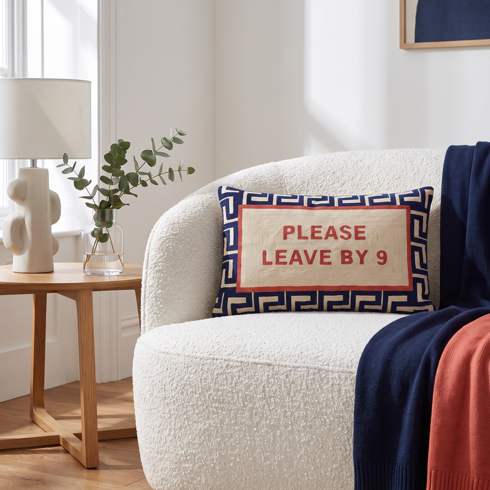 Please Leave By 9 needlepoint cushion styled at home