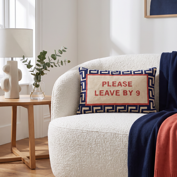 Please Leave By 9 needlepoint cushion styled at home